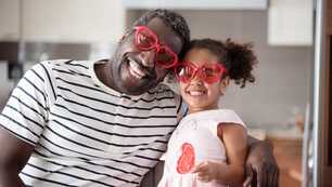 Father and Daughter wearing heart glasses