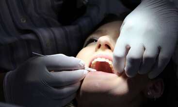 Dental patient having mouth examined 