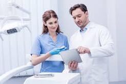 Dental Assistant and Dentist looking at chart