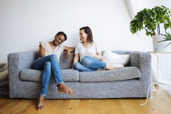 Two women sitting on couch