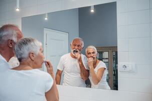 Picture of an older couple brushing their teeth together