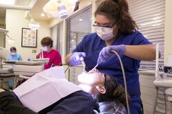 Dental Assistant  working on patient