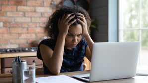 woman looking frustrated at computer