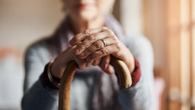 older woman holding cane