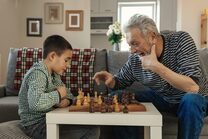 Grandpa and grandson playing chess