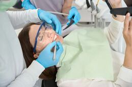Dental patient being worked on in dental operatory