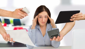 Woman with many devices and papers in her face looking overwhelmed