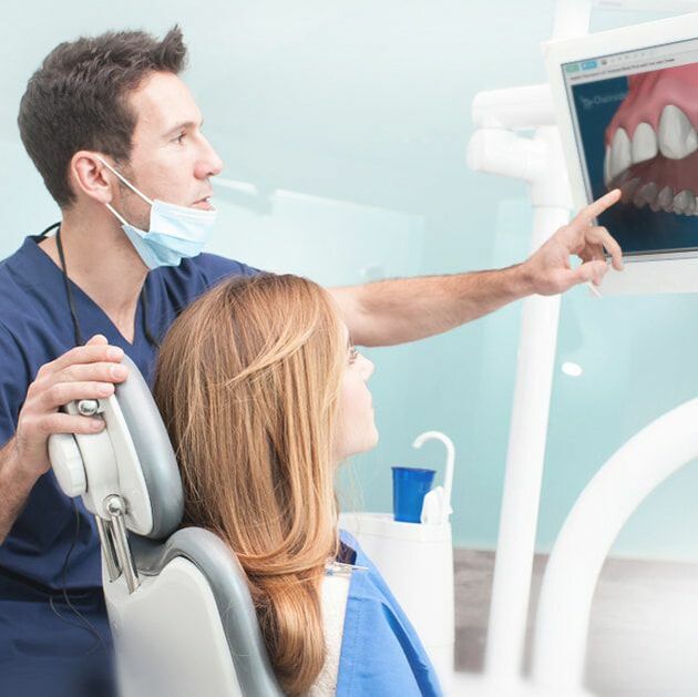 Dentist and Patient looking at X-ray