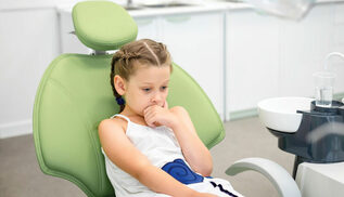 child sitting in dental chair